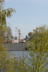 Giant yellow crane in the open air on the shore of the Moscow River.