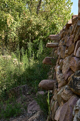 Fototapeta na wymiar Stone wall for the fields with stone steps to climb.