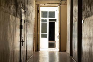 An old dark corridor is long in an office building in the city center in Ukraine, a door to the corridor, an exit, a building