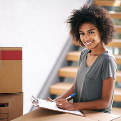 Looks like my to do list is fully checked. Shot of a young woman checking her clipboard while busy...