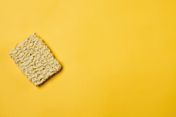 Instant noodles composition. Noodles and fresh vegetables and spices on yellow background