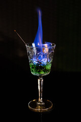 Delicious cocktail with alcohol served with garnish prepared by the bartender in the cocktail bar in dark colors