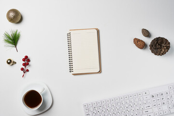 White Christmas, desk office with laptop, decoration and work supplies with cup of coffee. Top view with copy space for input the text. Flat lay desk table winter Christmas. Business Holidays Concept.
