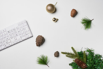 Fototapeta na wymiar Merry Christmas and Happy new years office work space desktop concept. Flat lay top view with laptop and Christmas ornaments white backgraund with copy space