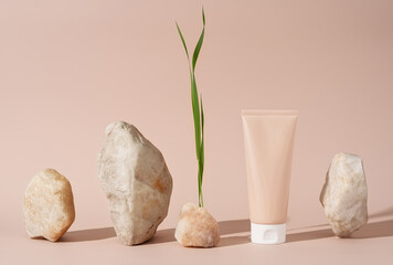 Cosmetic skin care product body lotion, shampoo, face cream or mask with pieces of white rock and grass on pastel background. Natural beauty and organic cosmetics concept with copy space for your