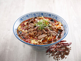 Poached Marbled Beef in Szechuan Style with chopsticks served in a dish isolated on mat side view on grey background