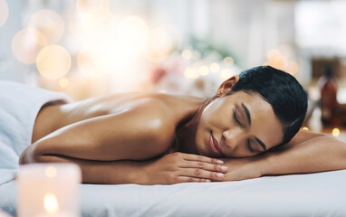 Fototapeta na wymiar Falling asleep. Shot of a relaxed an cheerful young woman getting a massage indoors at a spa.