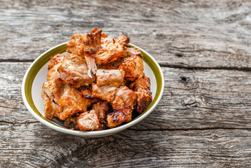 Shashlik grilled meat bbq in the bowl on the old gray oak table outdoors.Copy space.Closeup.