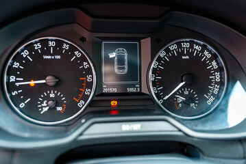Fototapeta premium Modern car speedometer,odometer,tachometer and illuminated dashboard. car dashboard modern automobile controlilluminated panel speed display.Car instrument panel.Close up.Selective focus.