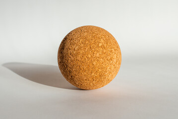 Nice brown cork ball lie on the white gray background.Copy space.