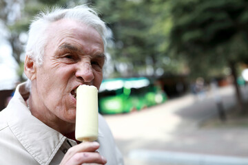 Senior man eating white chocolate ice cream
