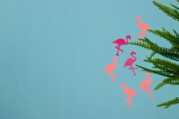 pink flamingos coming out of the rainforest on a pastel blue background, creative summer modern design, copy space