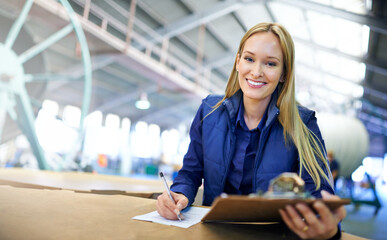 The warehouse couldnt be running any smoother. Portrait of a smiling manager reading paperwork...