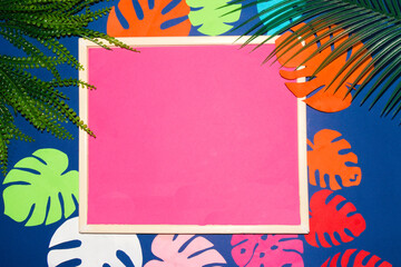 frame with pink copy space around colorful jungle leaves, creative tropical design, summer colors, clue background