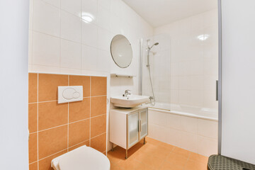 Wall hung toilet and small sink in corner in lavatory room with beige tile
