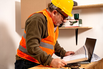 Caucasian contractor reviewing work schedule in the work office. Concept of labor organization,