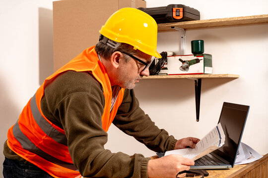 Caucasian contractor reviewing work schedule in the work office. Concept of labor organization,