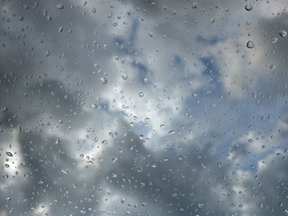 Rain drops on the window with cloud and sky background after the rain