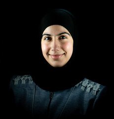 Attractive Muslim woman on black background. High quality photo