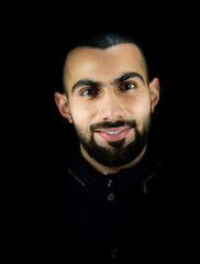Portrait of young attractive man on a black background. High quality photo