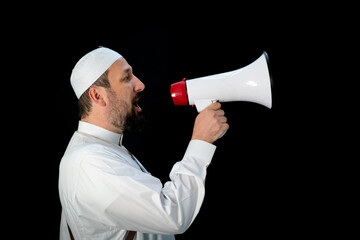 Handsome man with beard shouting through megaphone for Hajj in Mekkah