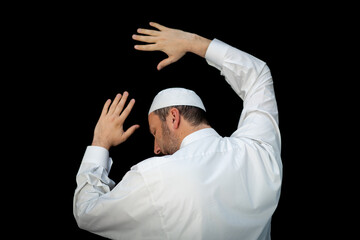 Naklejka premium Muslim man standing and praying in the front of Kaaba in Mecca, KSA