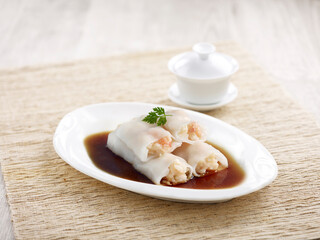 Steamed Rice Rolls with Fresh Prawn Filling with chopsticks served in a dish isolated on mat side view on grey background