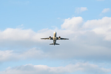 Fototapeta na wymiar plane taking off on a background of a blue sky
