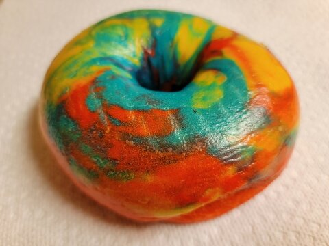 Colorful Bright Rainbow Bagel With Many Colors On Counter