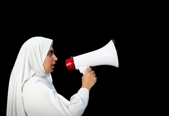 Fototapeta premium Arabic woman with hijab shouting through megaphone for Hajj in Mecca