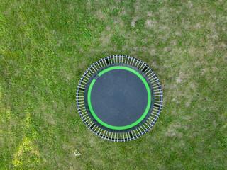 mini trampoline for fitness exercising and rebounding in a backyard, aerial view