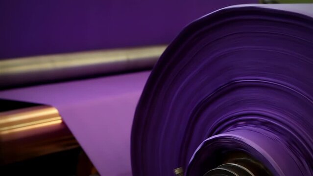 Purple Paper Reel Rolling at a Paper Machine in Pulp and Paper Mill Plant. Close Up. 4K Resolution.
