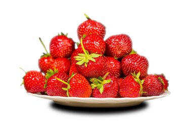 closeup heap of red ripen strawberry on dish isolated on white background