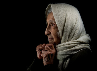 Elderly woman with kerchief, studio portrait. High quality photo