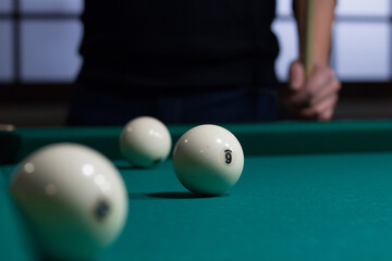 Russian billiards white balls on green table cloth and player