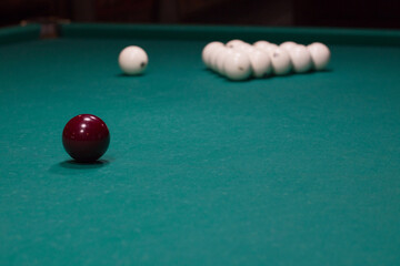 Russian billiards:  black and white balls on green game table