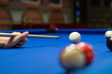 Eight-ball pool player aims to shoot balls with cue
