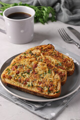 Hot sandwiches with potatoes and sausage in a plate and cup of coffee on gray table