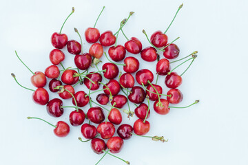 Obraz na płótnie Canvas Lots of sweet red cherries closeup. Red cherries isolated on a white background