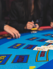 Poker table view with a pack of cards, tokens, alcohol drinks, dollar money and group of gambling rich wealthy people playing poker in casino, with croupier