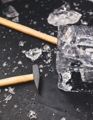 Process of breaking the ice with hammer and ice pick, group of people smashing shattered ice cube,...