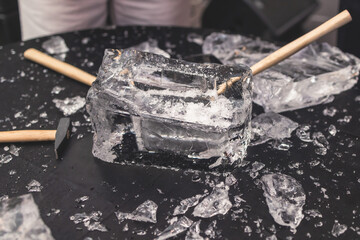 Process of breaking the ice with hammer and ice pick, group of people smashing shattered ice cube, team work success concept, concept of starting event, conversation - obrazy, fototapety, plakaty