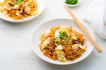 stir fried instant noodle with meatballs and vegetables with yakisoba sauce in white plate
