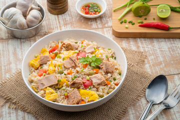 Tuna fried rice, Pan stir fry cooked rice with canned tuna fish ,tomato ,carrot ,peas and egg.Quick and Easy one dish meal on white plate