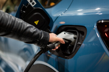 Power supply connect to electric vehicle for charge to the battery. . EV fuel Plug in hybrid car. 