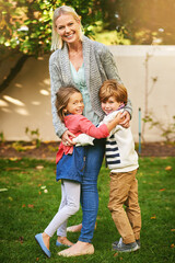 Fototapeta premium Hugs filled with an abundance of love. Portrait of two adorable siblings hugging their mother outside.