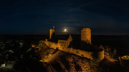 Image of illuminated Muenzenberg castle ruin in Germany in the evening