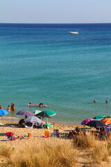 The beach of san pietro in bevagna with a lot of people