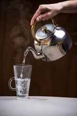 kettle pouring very hot water to prepare a coffee, diet concept