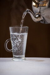 Close up of kettle serving very hot water to prepare a coffee, diet concept.